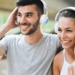 Man and woman listening through headphones