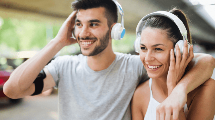 Man and woman listening through headphones